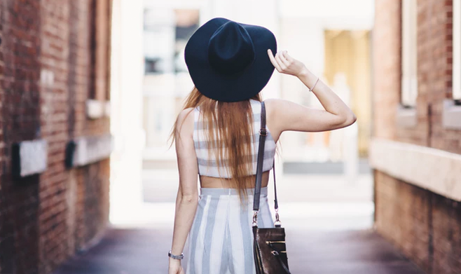 Model wearing sunhat, stipped top and stripped pants