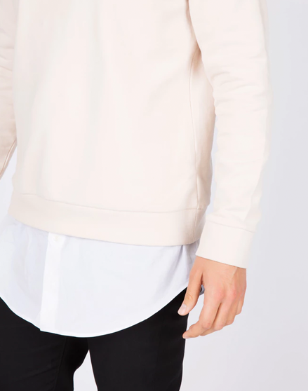Modeling white dress shirt with a cream sweater.