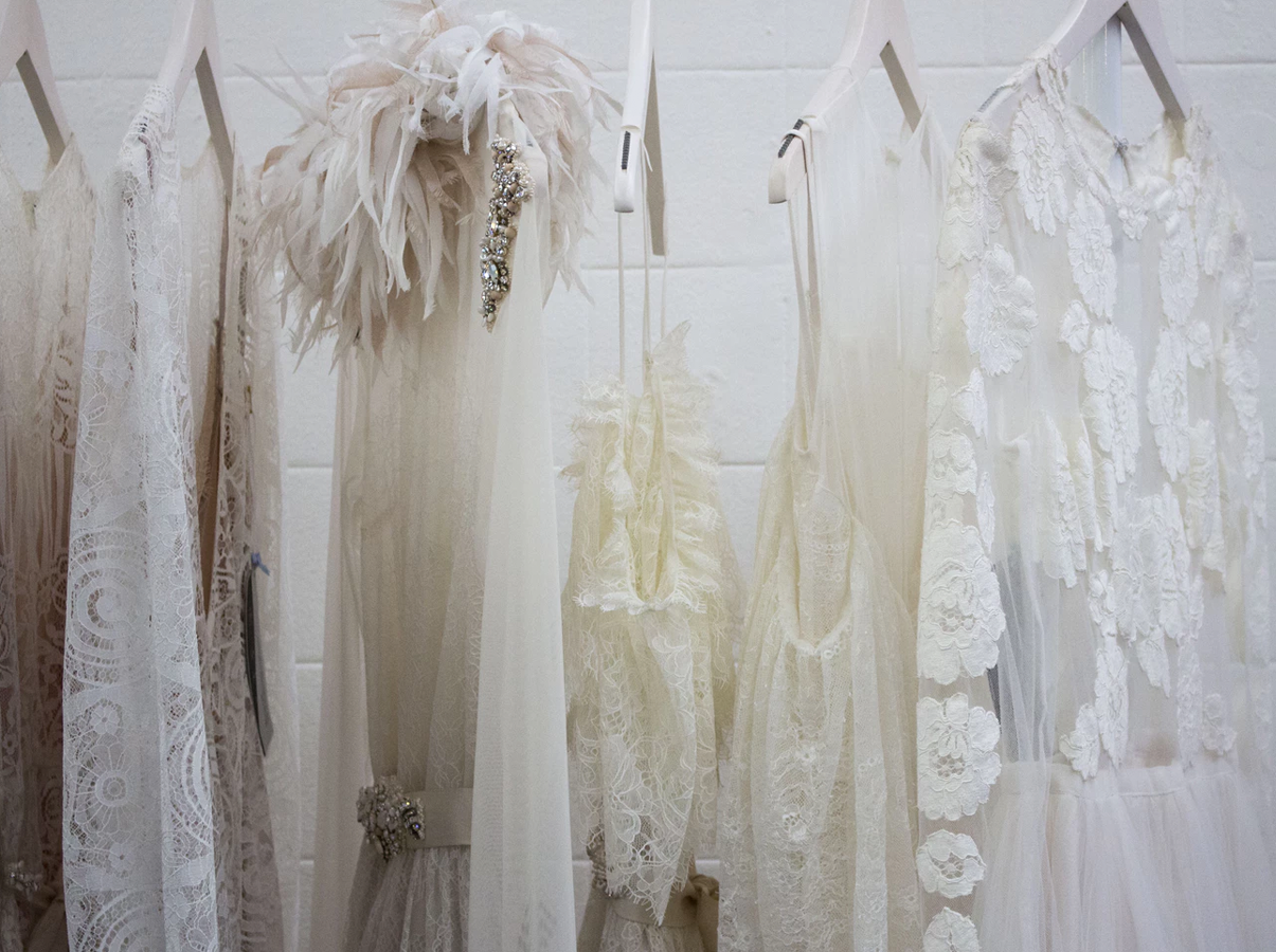 White dresses hanging on white hangers